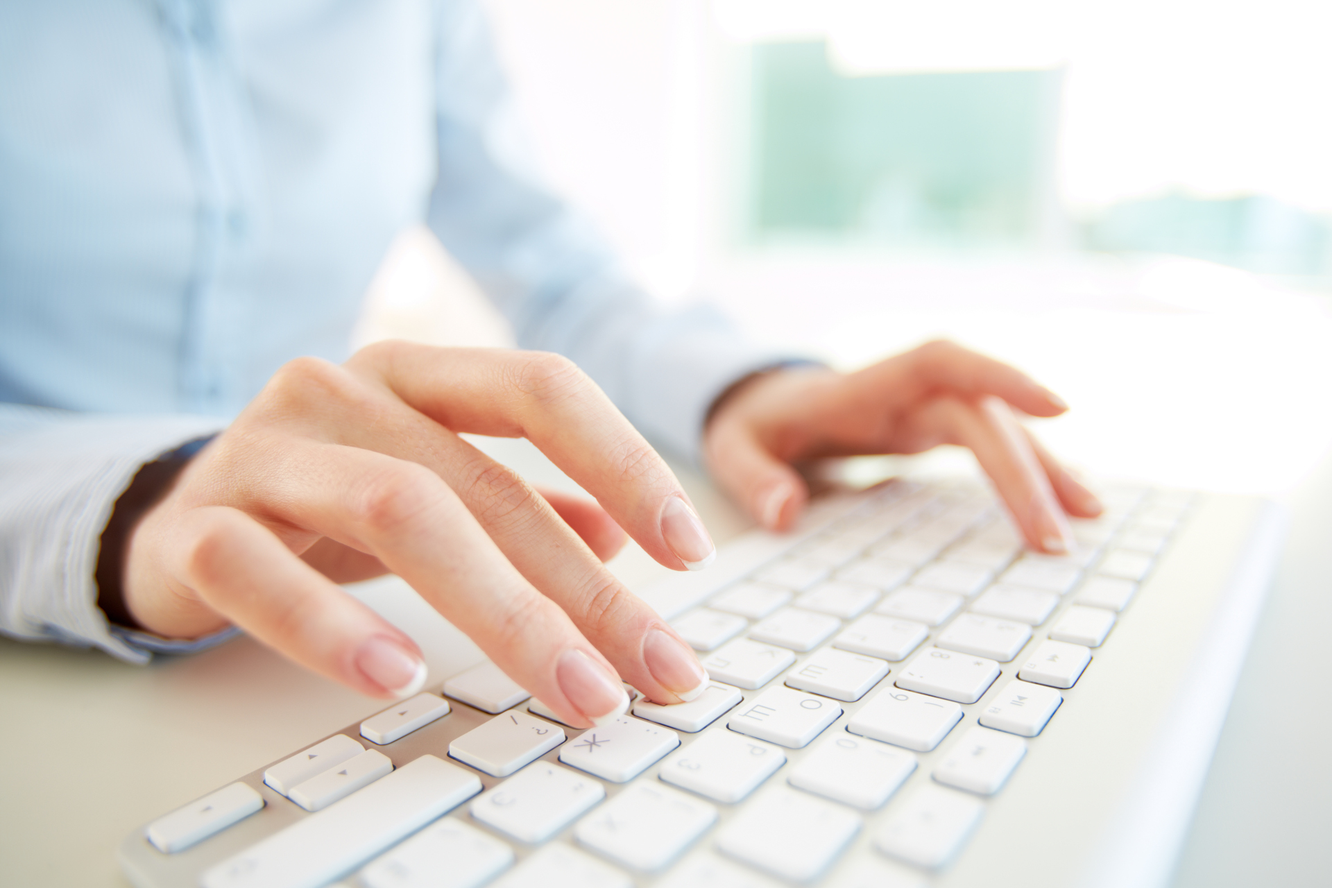 Hands of an office woman typing